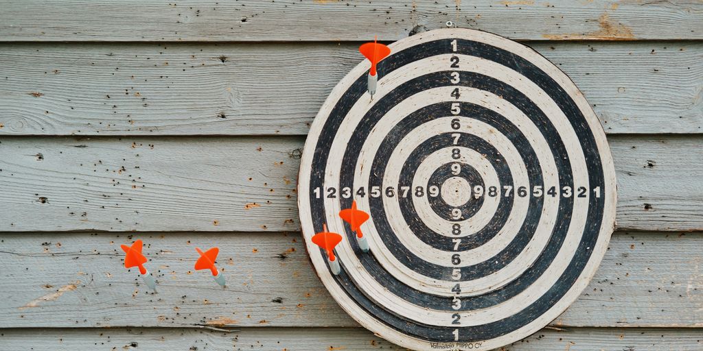 darts board with orange darts